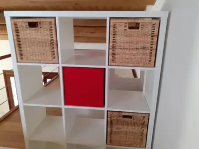 a white book shelf with a red box at Case Vacanze Azzurra, Loredana e Trinacria in Castellammare del Golfo