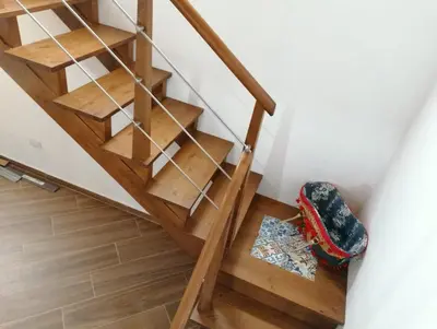 a stairwell with wooden stairs and a rug on the floor at Case Vacanze Azzurra, Loredana e Trinacria in Castellammare del Golfo