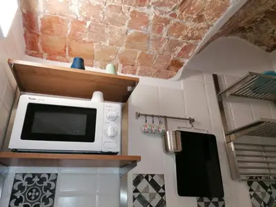 a microwave sitting on a counter in a kitchen at Case Vacanze Azzurra, Loredana e Trinacria in Castellammare del Golfo