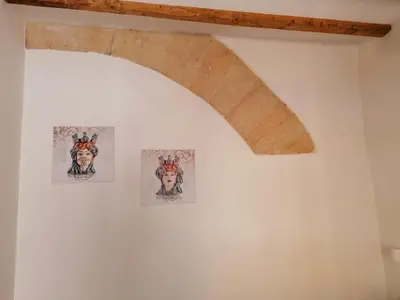 a ceiling with three pictures on a white wall at Case Vacanze Azzurra, Loredana e Trinacria in Castellammare del Golfo