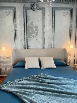 a bedroom with a blue bed with two pillows at Deliziosa Villa a 500 metri dal mare con Piscina in Terrasini