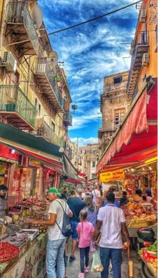 a group of people walking through a market at Ncantu home in Palermo