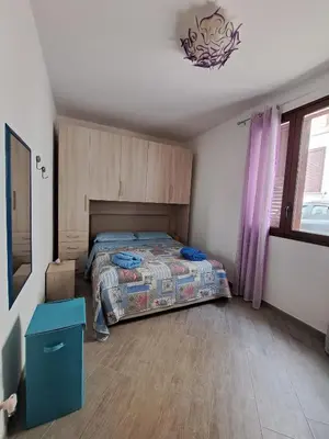 a bedroom with a bed in the middle of it at Bea's House in Castellammare del Golfo