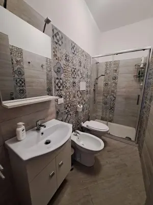 a bathroom with a sink and a toilet and a shower at Bea's House in Castellammare del Golfo