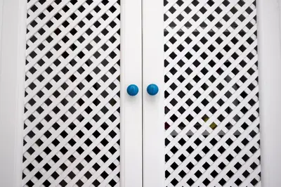 a white door with blue balls on it at Casa Greta a due passi dal mare in San Vito lo Capo