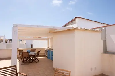 a view of a balcony with a table and chairs at Casa Greta a due passi dal mare in San Vito lo Capo