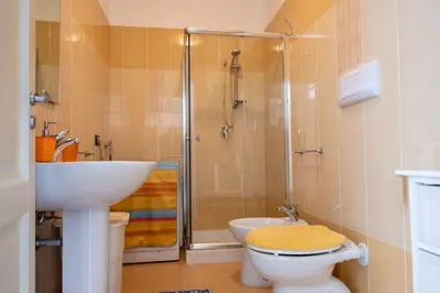 a bathroom with a shower and a toilet and a sink at Casa Greta a due passi dal mare in San Vito lo Capo