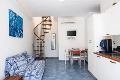 a living room with a couch and a table at Casa Greta a due passi dal mare in San Vito lo Capo
