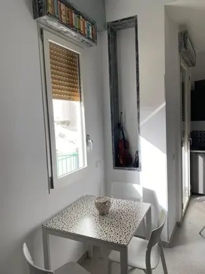 a table and chairs in a room with a window at Palermo City Room in Palermo