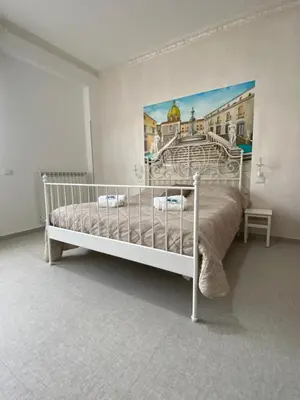 a bedroom with a bed with a painting on the wall at Palermo City Room in Palermo