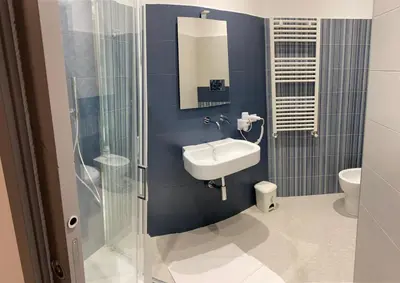 a bathroom with a sink and a shower at Palermo City Room in Palermo