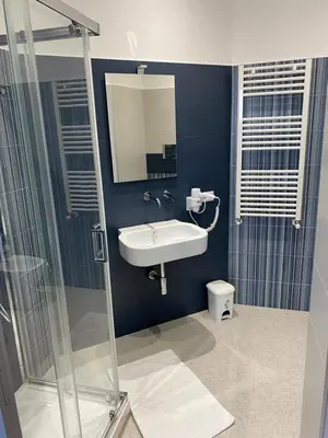 a bathroom with a sink and a shower at Palermo City Room in Palermo