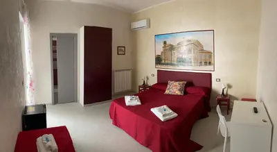 a bedroom with a red bed with a red blanket at Palermo City Room in Palermo