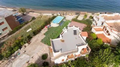an aerial view of a house with a swimming pool and the ocean at Villa Silvia by Ville in Palermo in Casteldaccia