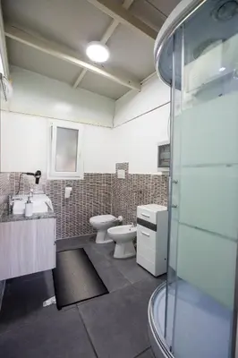 a bathroom with a toilet and a sink and a shower at Villa Silvia by Ville in Palermo in Casteldaccia