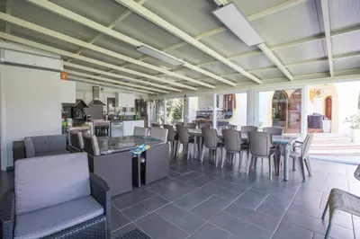 a restaurant with a bar and chairs and a kitchen at Villa Silvia by Ville in Palermo in Casteldaccia