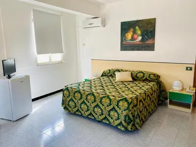 a hotel room with a bed and a television at Franco Il Conte in Bagheria