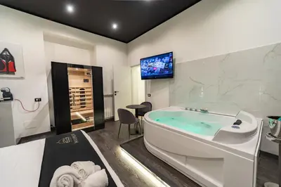 a large bathroom with a tub and a tv at Maximum Suite & Spa in Palermo