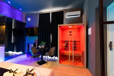 a room with a table and chairs and a room with a bedroom at Maximum Suite & Spa in Palermo
