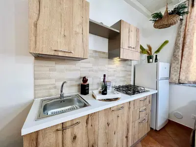 a kitchen with a sink and a refrigerator at da Mumminedda in Cinisi