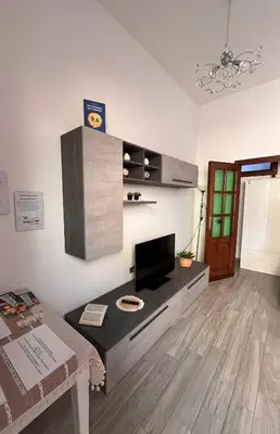 a living room with a television and a table at da Mumminedda in Cinisi
