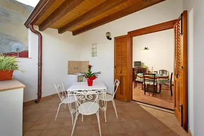 a kitchen and dining room with a table and chairs at Apartment, Castellammare del Golfo in Castellammare del Golfo