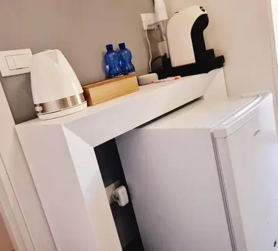 a shelf on a refrigerator with blue bottles on it at SCRUSCIU HOME in Terrasini