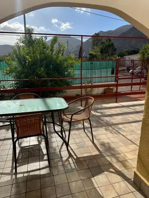 a table and two chairs on a patio with a view at Mondello Sabrina Apartments in Mondello
