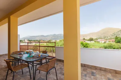 a table and chairs on a balcony with a view at Mondello Sabrina Apartments in Mondello
