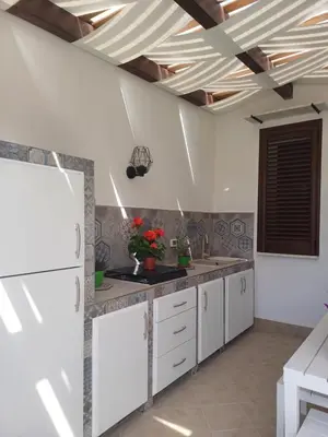 a kitchen with white cabinets and a coffered ceiling at Terra Sinus Beautiful Suite in Terrasini
