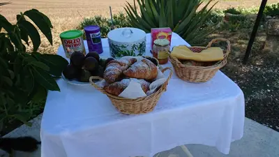 a table with two baskets of bread and food on it at Helimos B&B with Segesta Temple view near Castellammare del Golfo in Calatafimi