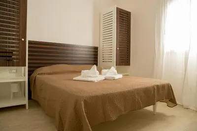 a bedroom with a bed with towels on it at SanvitoTour - Scala del Mare in San Vito lo Capo