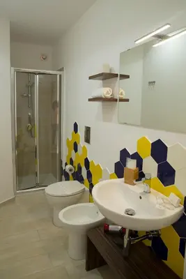 a bathroom with a sink and a toilet at SanvitoTour - Scala del Mare in San Vito lo Capo