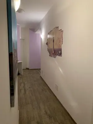 a hallway with a painting on a white wall at BONORUM De Spuches in Palermo