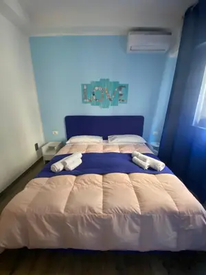 a bedroom with a large bed with two towels on it at BONORUM De Spuches in Palermo