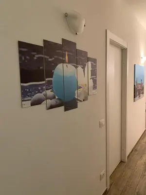 a hallway with five paintings on a wall at BONORUM De Spuches in Palermo