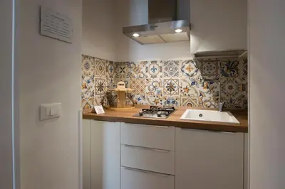a kitchen with a sink and a counter top at Capo Rama Suites & Rooms in Terrasini