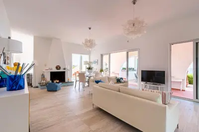 a living room with a white couch and a tv at Splendida Villa con vista mozzafiato e piscina in Terrasini