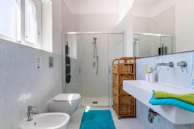 a bathroom with a sink and a toilet and a shower at Splendida Villa con vista mozzafiato e piscina in Terrasini