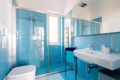 a blue bathroom with a sink and a toilet at Splendida Villa con vista mozzafiato e piscina in Terrasini