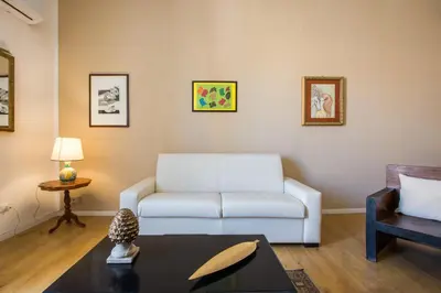a living room with a white couch and a table at Cathedral View Apartments in Palermo