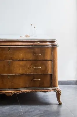 a wooden chest of drawers with a marble top at Cathedral View Apartments in Palermo