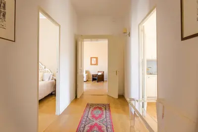 a hallway with a room with a bed and a rug at Cathedral View Apartments in Palermo