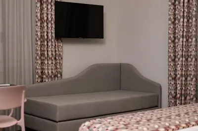 a living room with a couch and a tv on the wall at Bri&Bri Mondello in Palermo