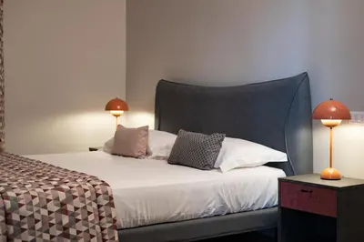 a bedroom with a bed with two lamps on it at Bri&Bri Mondello in Palermo