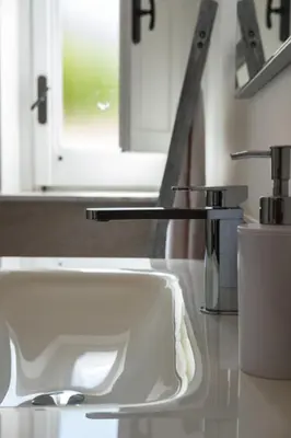 a white sink in a bathroom with a window at Bri&Bri Mondello in Palermo