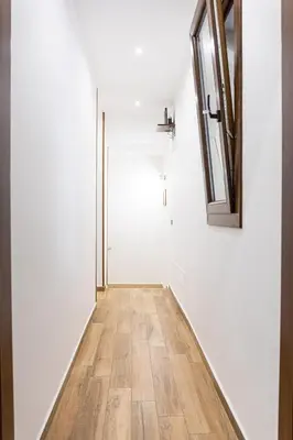 a hallway with white walls and a wooden floor at Casa Vacanze del Corso in Bagheria