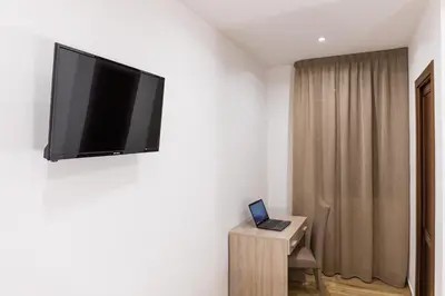 a room with a flat screen tv on a wall at Casa Vacanze del Corso in Bagheria