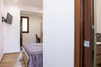 a bedroom with a bed and a tv in a room at Casa Vacanze del Corso in Bagheria