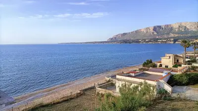 a view of a beach with a house and the ocean at LA FINESTRA SUL MARE PIANO Terra in Trappeto